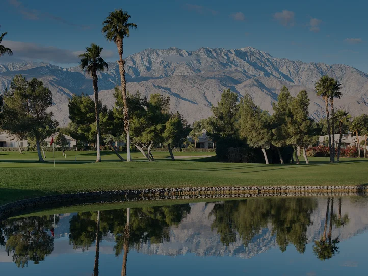 Pristine golf course fairway in Palm Springs with snow-capped San Jacinto Mountains backdrop