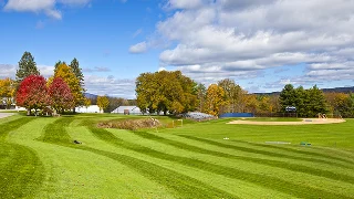 Pristine golf course with manicured fairways and autumn foliage under blue skies in Scottsdale