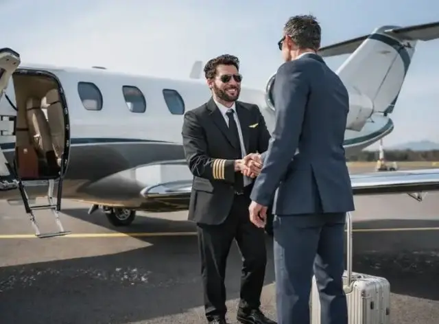 Pilot shaking hands with a business traveller beside a private jet, representing the Jetbay Global Partner Program